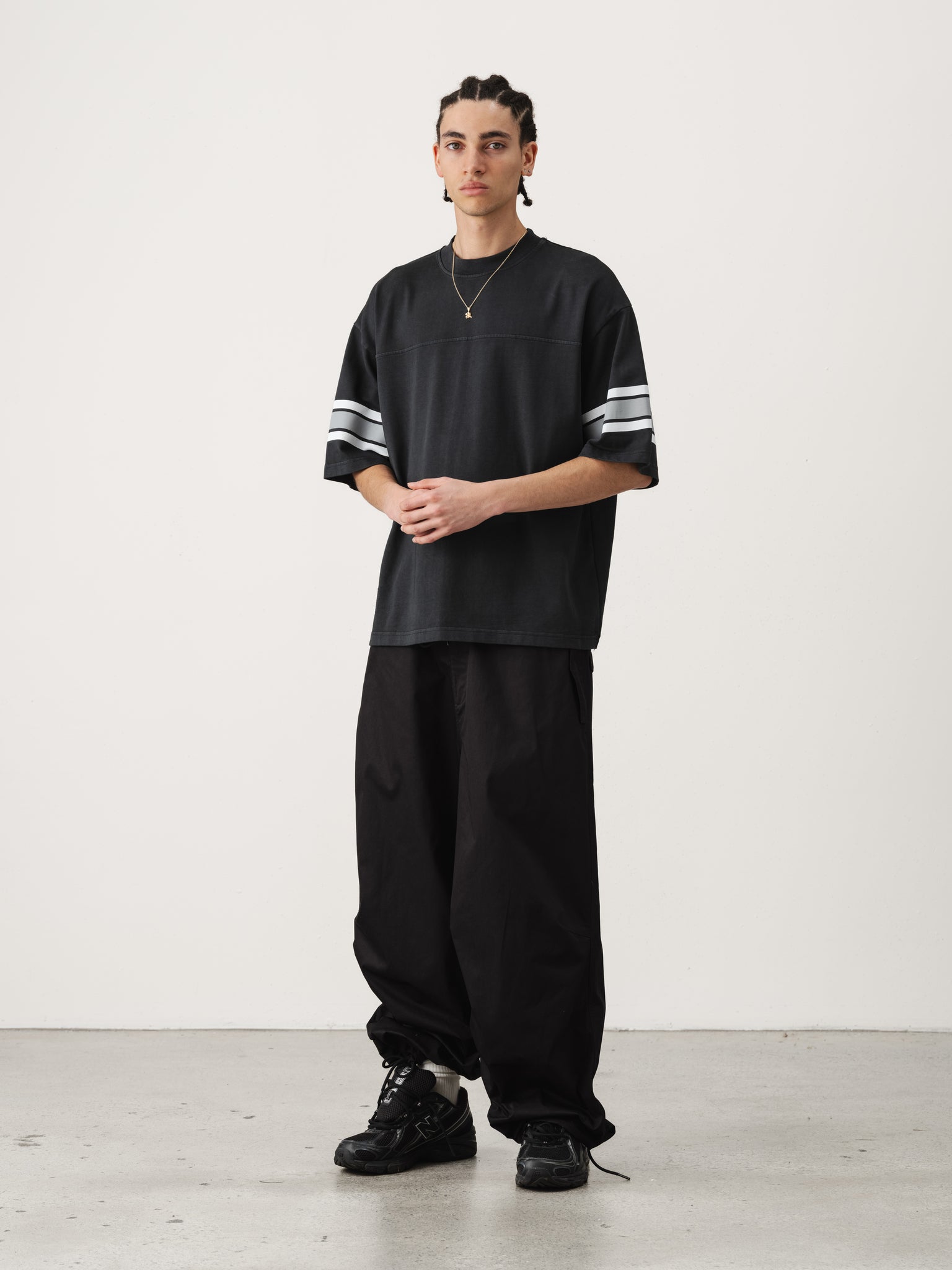 Washed black short-sleeve jersey t-shirt from SWEATS EU, displayed on a hanger with a casual, relaxed fit.
