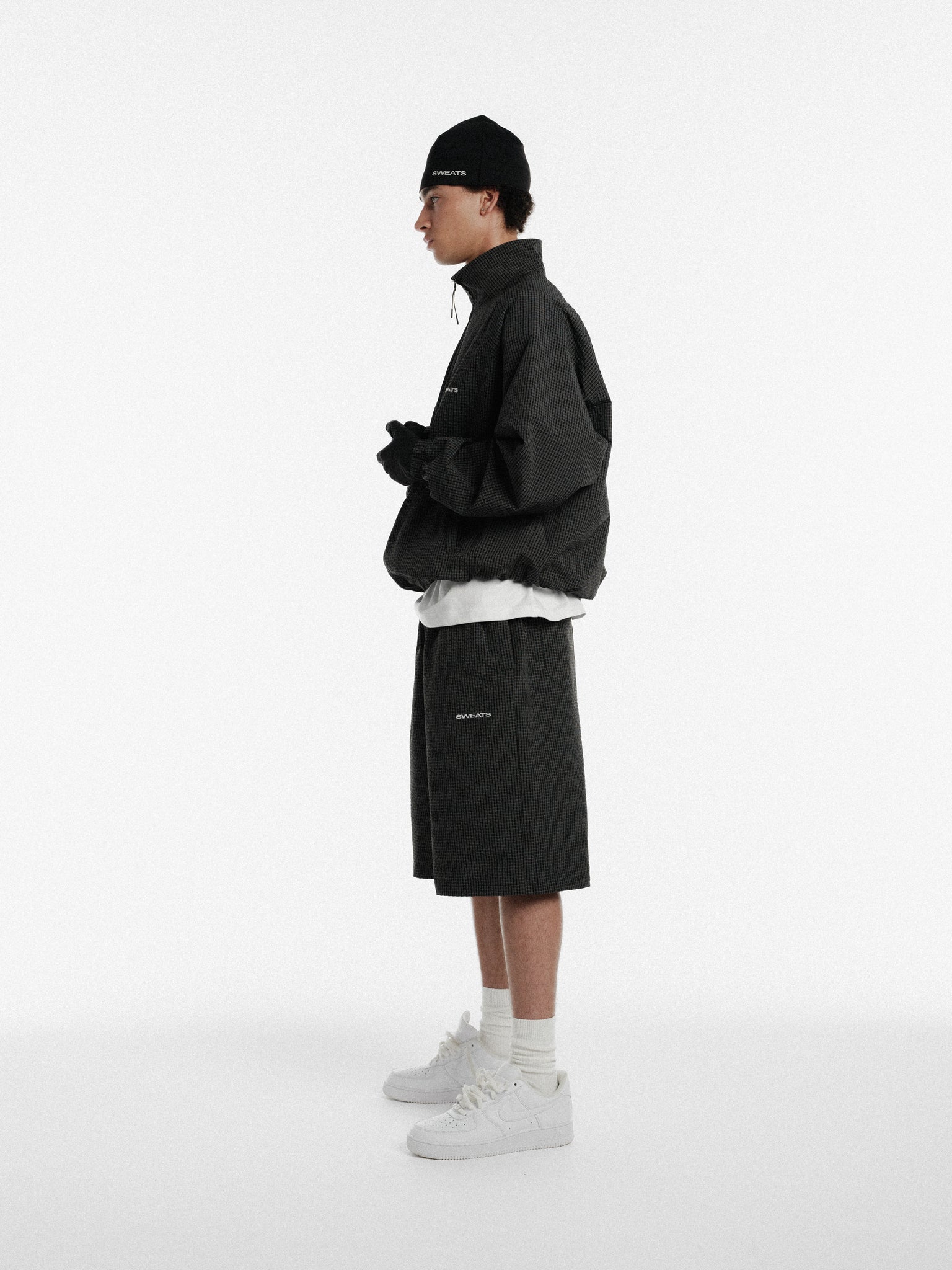 Black and white checkered track shorts by Sweats EU, casual athletic shorts with a sporty design.