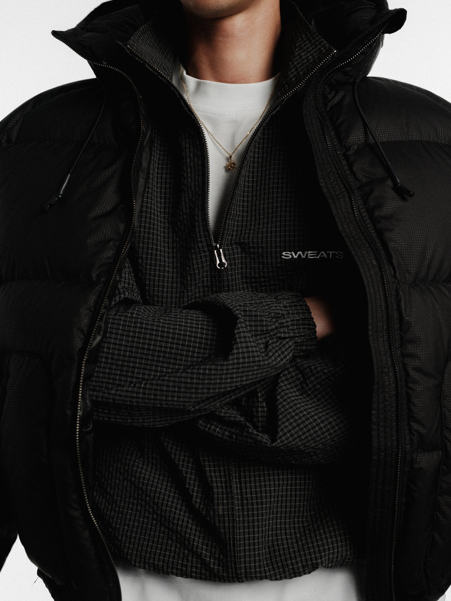 Black and white checkered track jacket by SWEATS EU with a sporty design, shown on a mannequin.