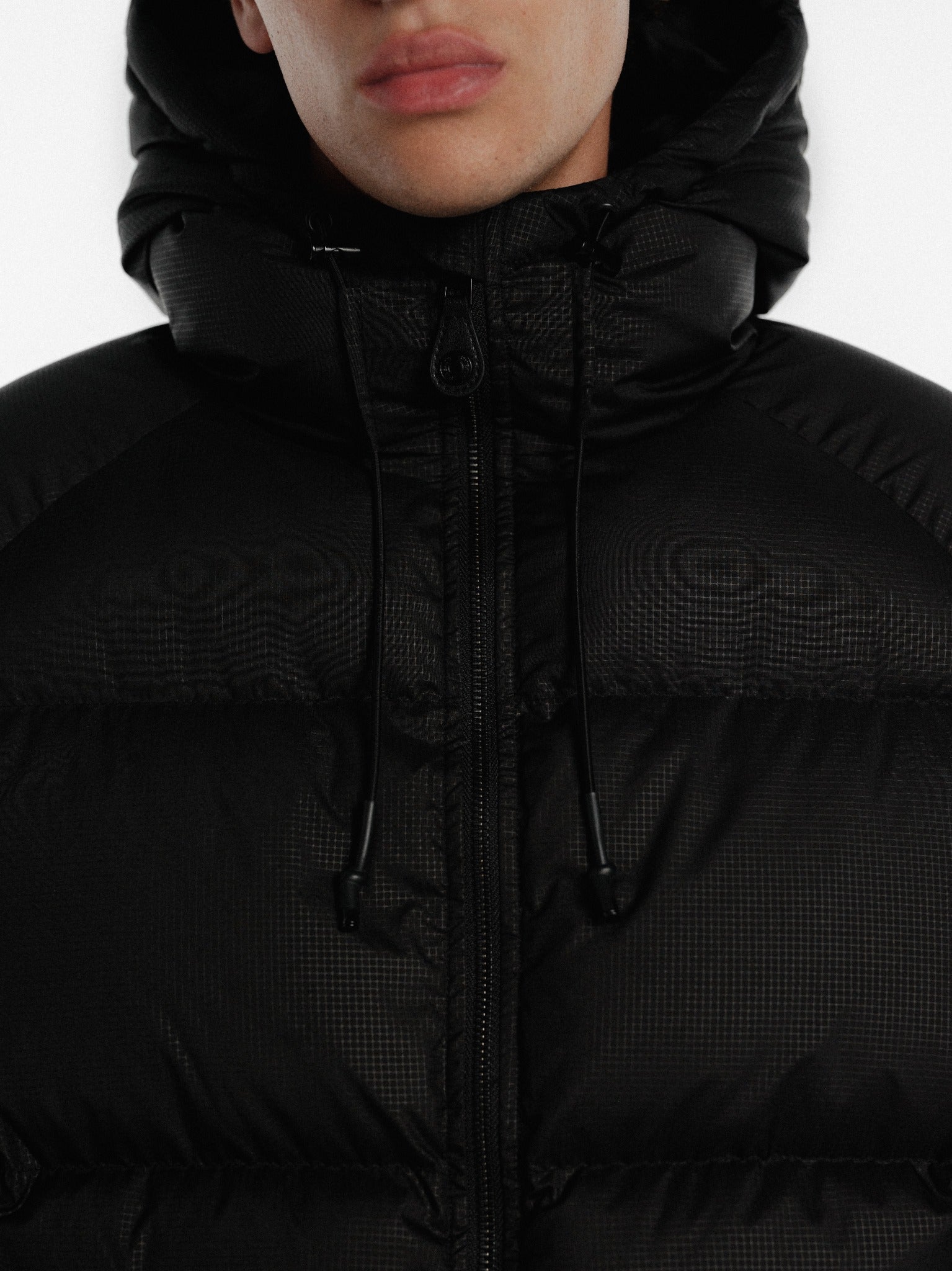 Black hooded puffer jacket by SWEATS EU, featuring a padded design and cozy hood for winter warmth.
