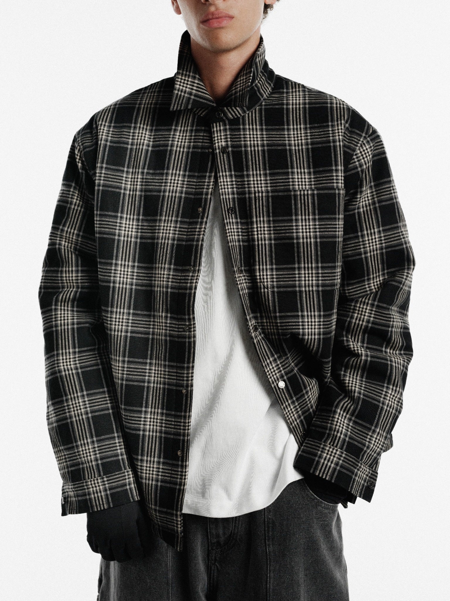 Black flannel jacket by SWEATS EU, showing a cozy, button-up design with a classic collar and plaid pattern.