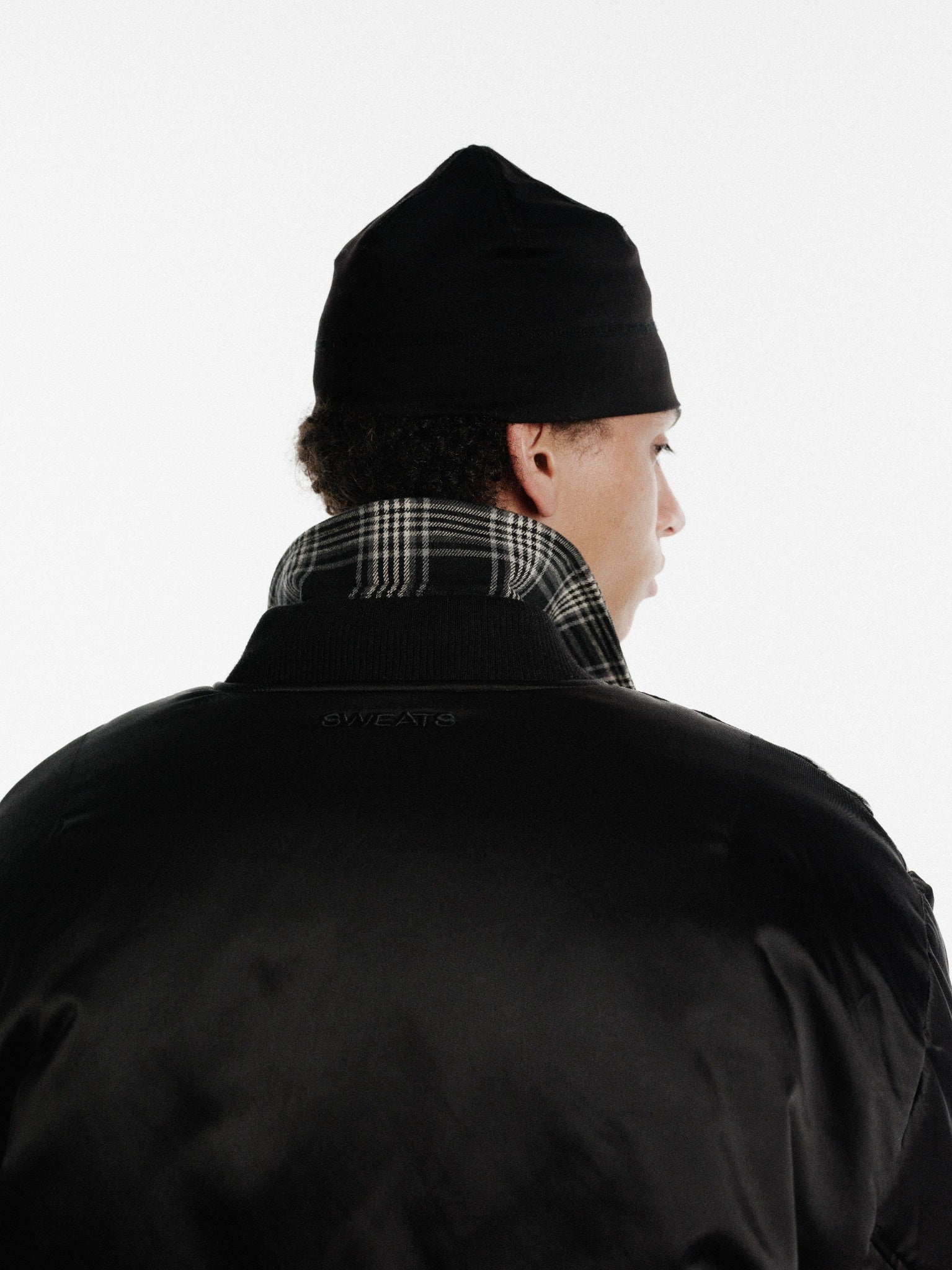 Black bomber jacket from SWEATS EU featuring a sleek design and ribbed cuffs, perfect for casual winter wear.