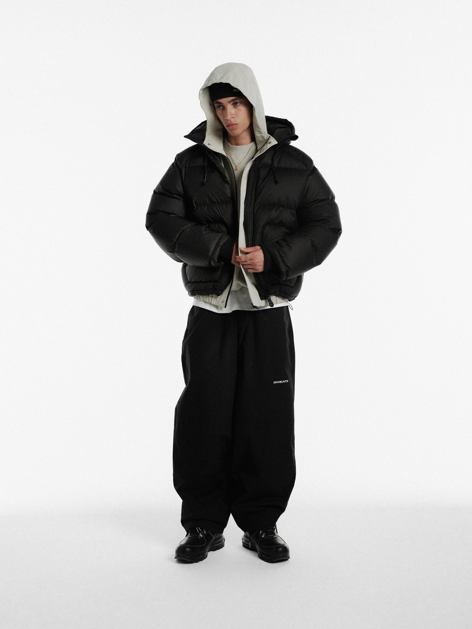 Stone-colored ARC jacket by SWEATS EU displayed on a hanger, showcasing its stylish winter urban outerwear design.