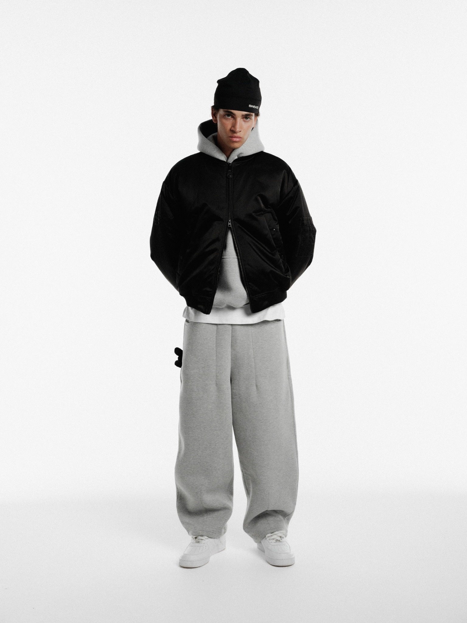 Black bomber jacket by Sweats EU, featuring a stylish design and zip-front closure, displayed on a plain background.