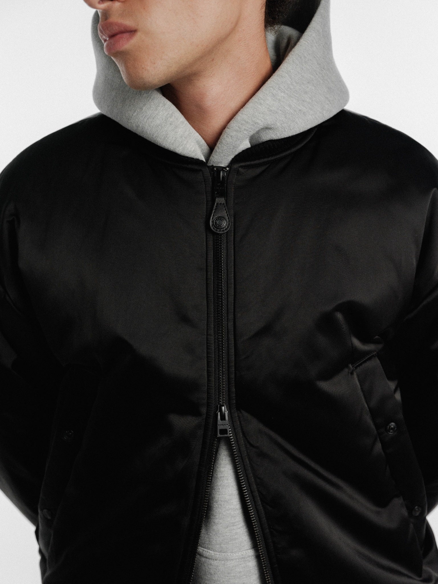 Black bomber jacket by SWEATS EU with a stylish, fitted design and ribbed cuffs, displayed on a hanger.