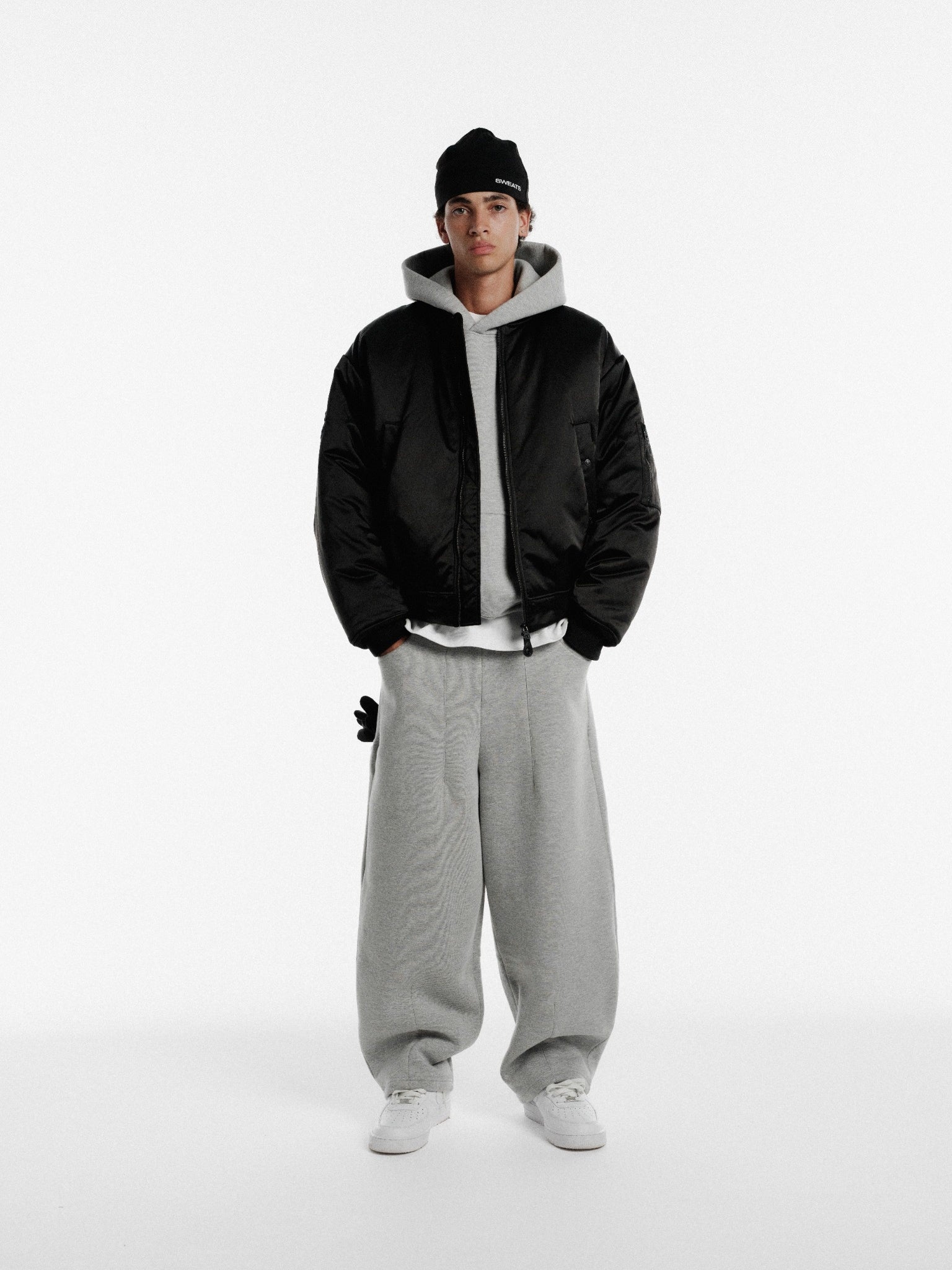 Black bomber jacket from SWEATS EU featuring a classic design and ribbed cuffs, ideal for casual winter wear.
