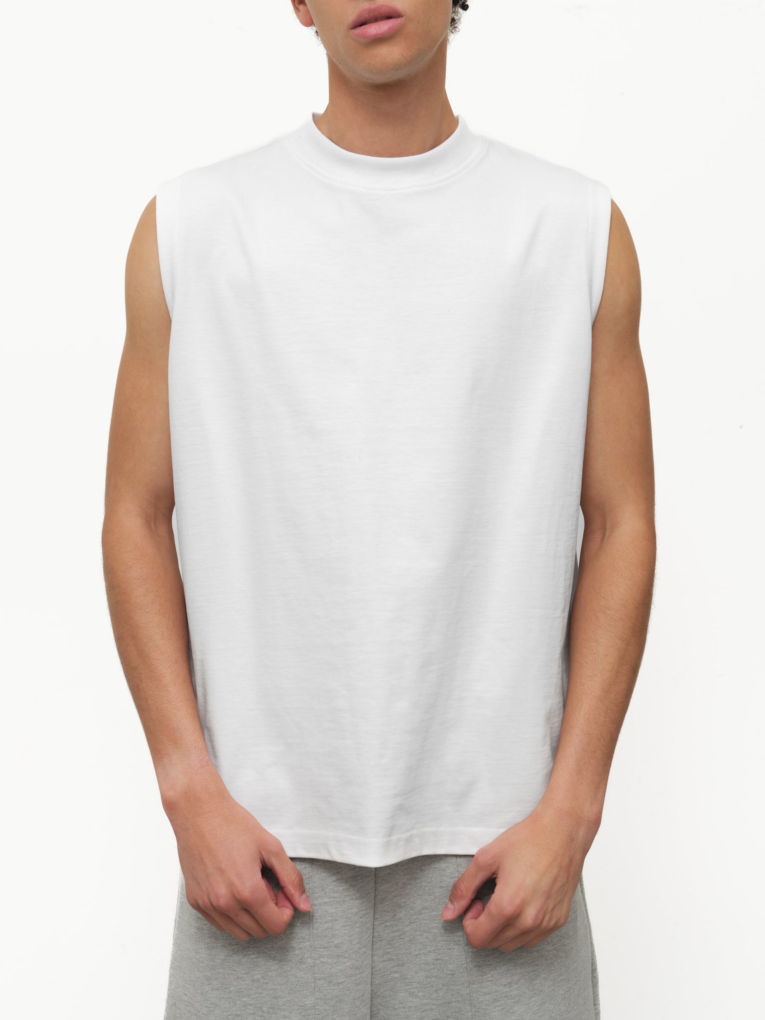 White muscle tee shirt by SWEATS EU displayed on a mannequin, showcasing sleeveless athletic style and casual fit.