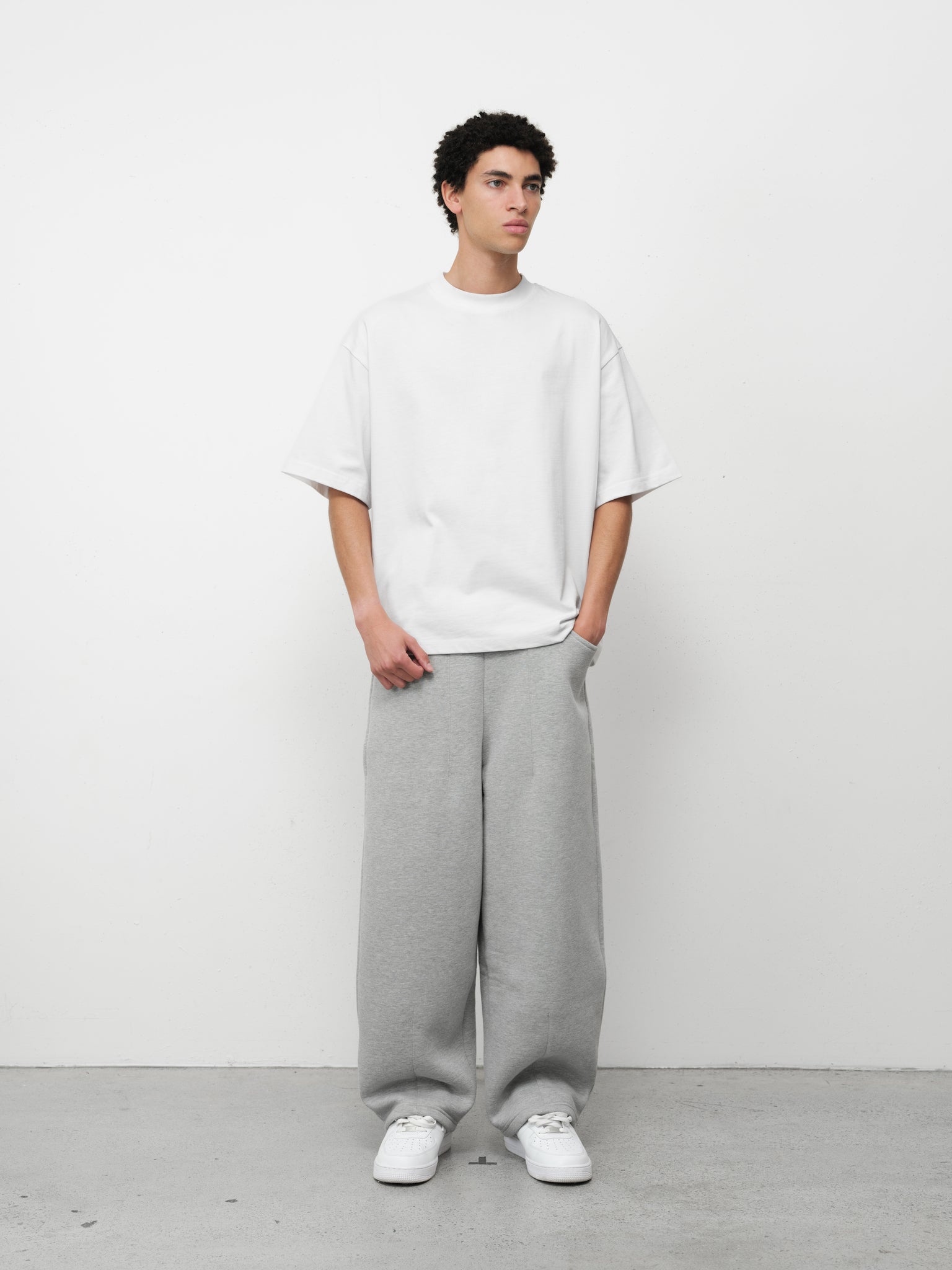 Pure white Signature Blank T-shirt by Sweats EU displayed on a model, showcasing its classic fit and clean design.