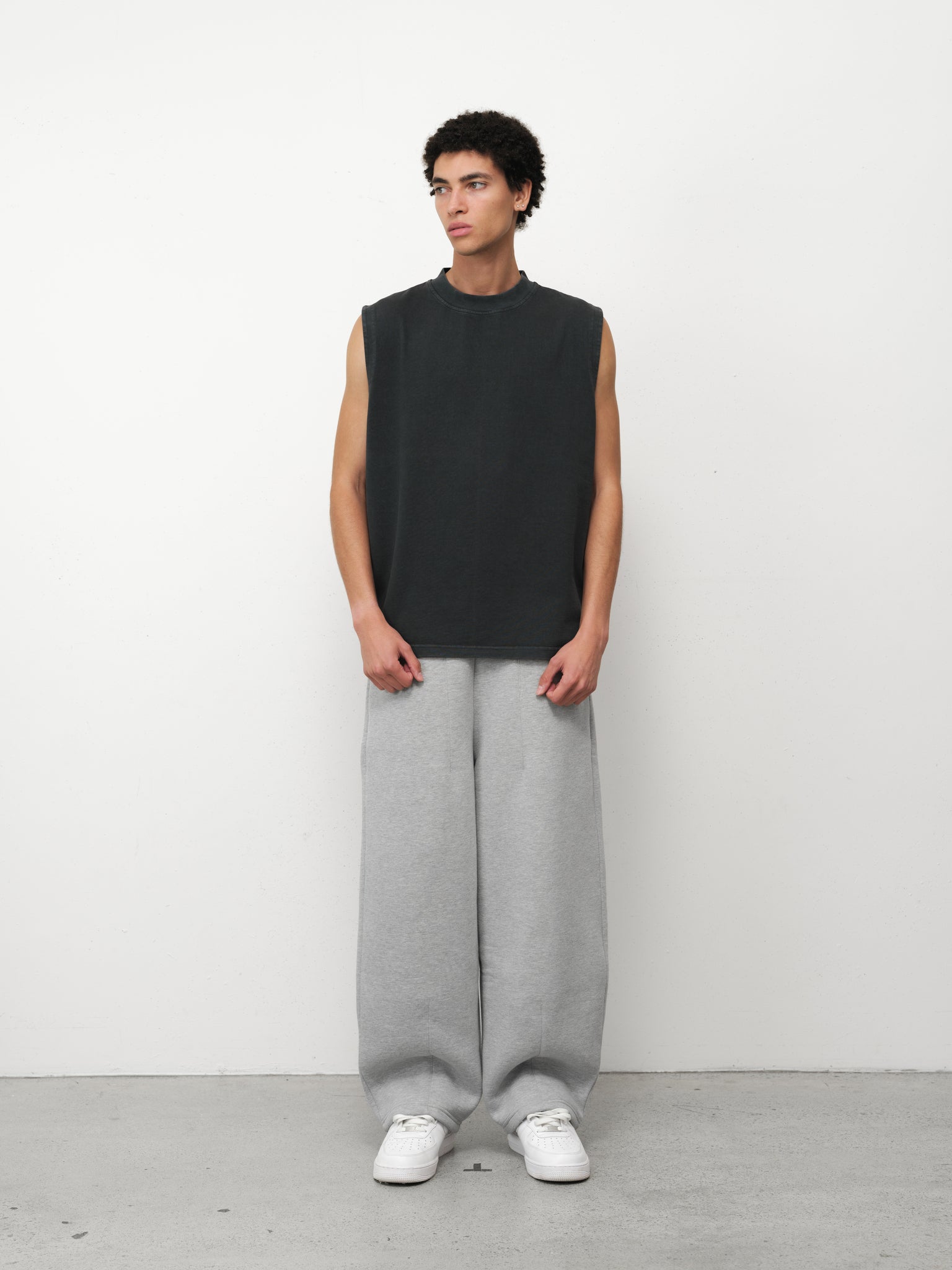 WASHED BLACK Muscle Tee by SWEATS EU displayed on a model, showcasing a casual sleeveless black tank top for athletic and streetwear styles.
