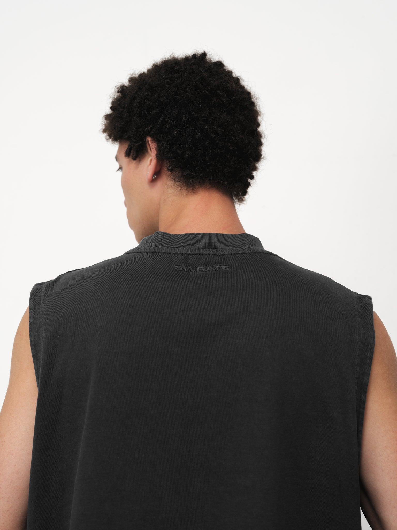 Black washed muscle tee by SWEATS EU displayed on a model, showcasing its relaxed fit and casual style.