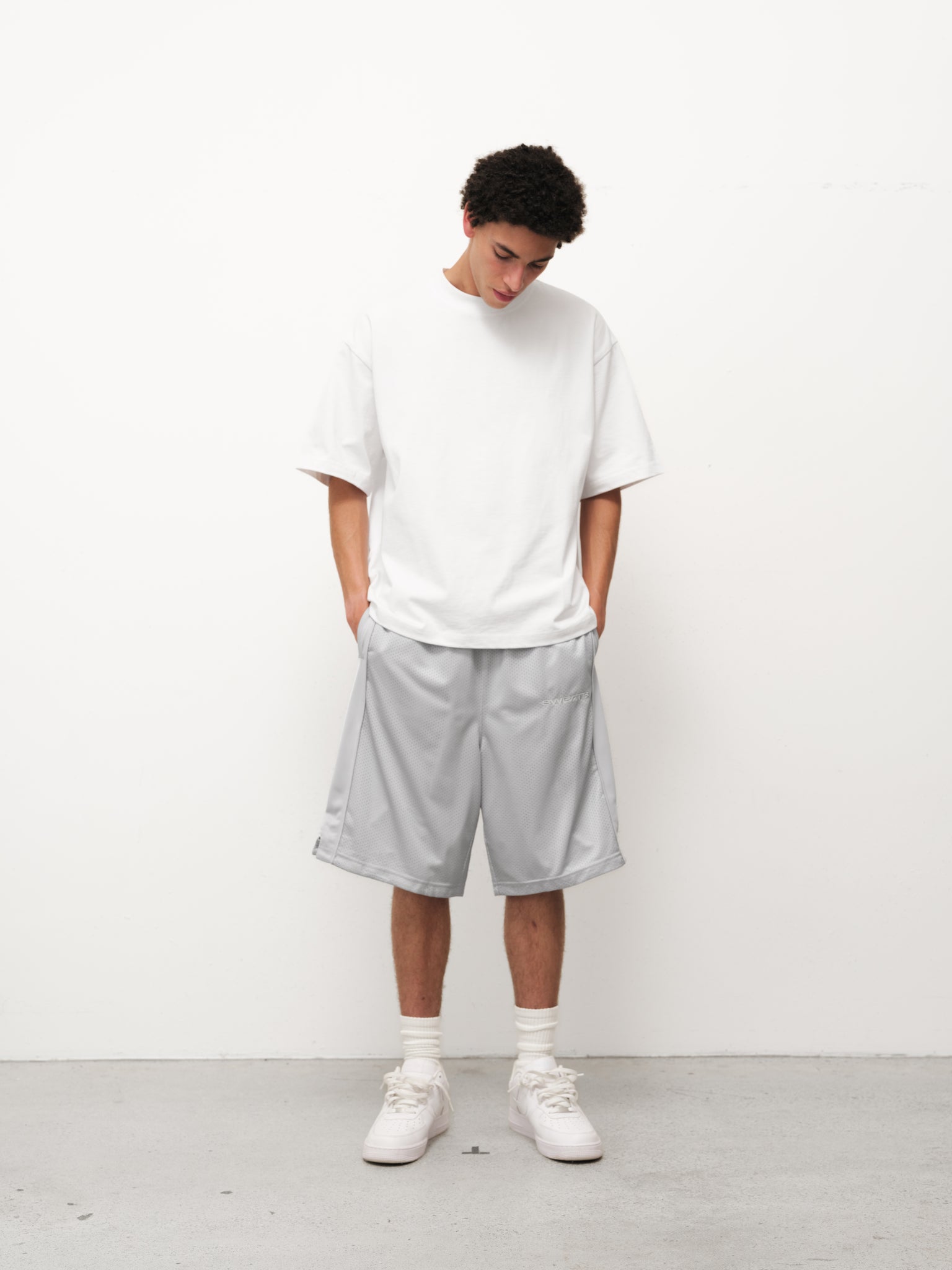 Grey mesh shorts from Sweats EU displayed on a neutral background, showcasing the fabric texture and fit.