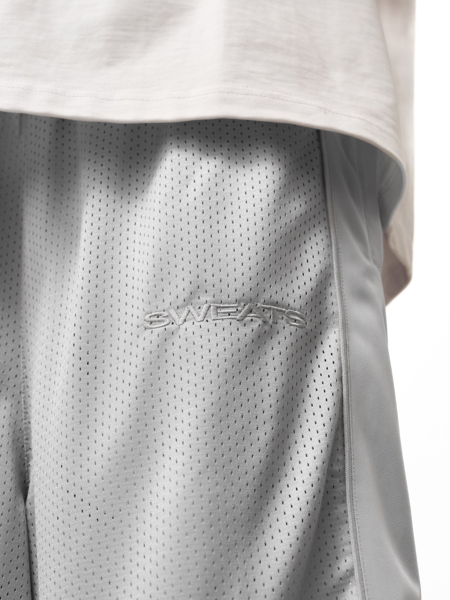 Grey mesh shorts by Sweats EU, featuring a comfortable fit and breathable fabric, ideal for active wear or casual outings.