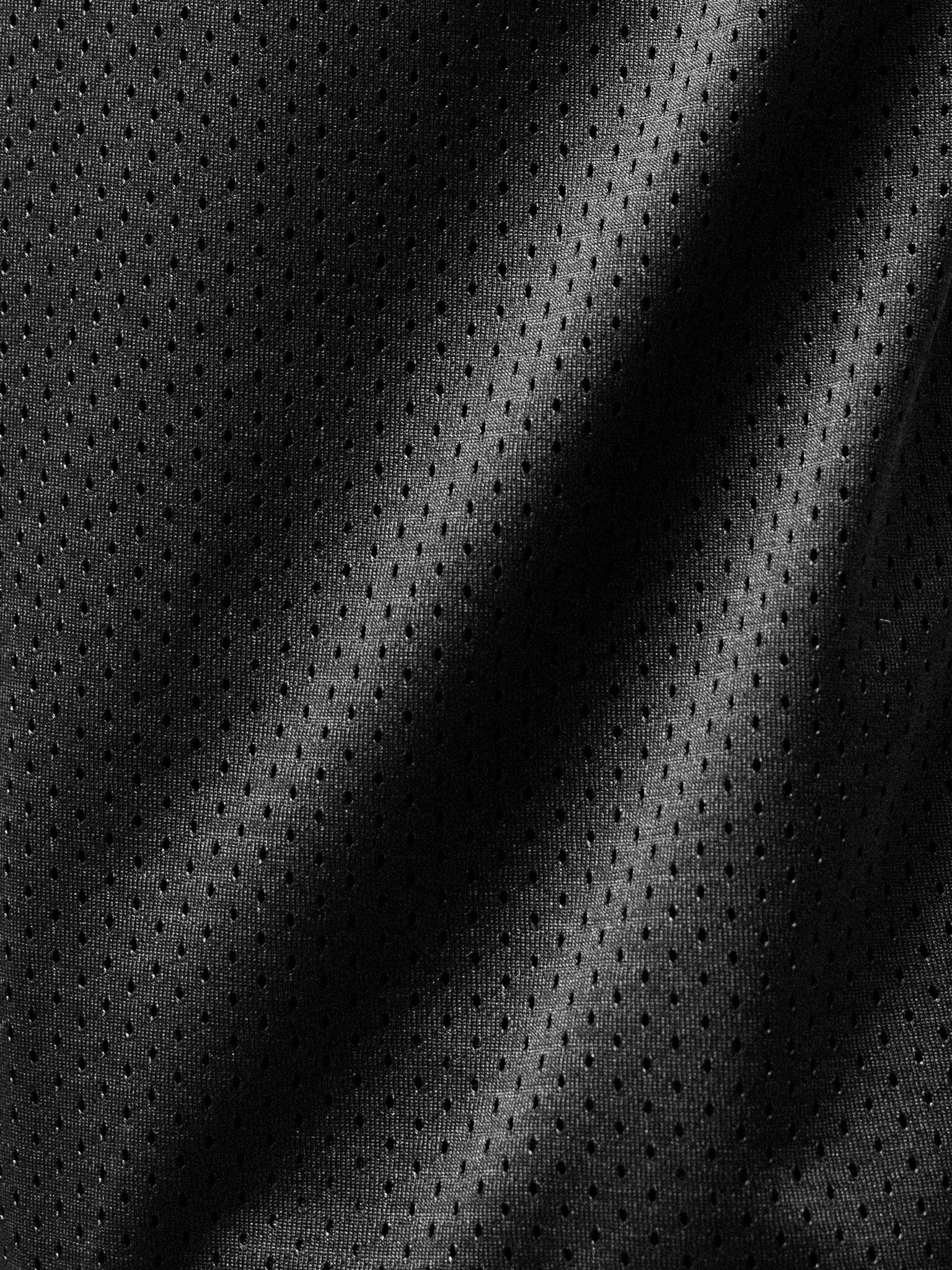 Black mesh shorts from Sweats EU displayed on a flat surface with visible texture and design details.