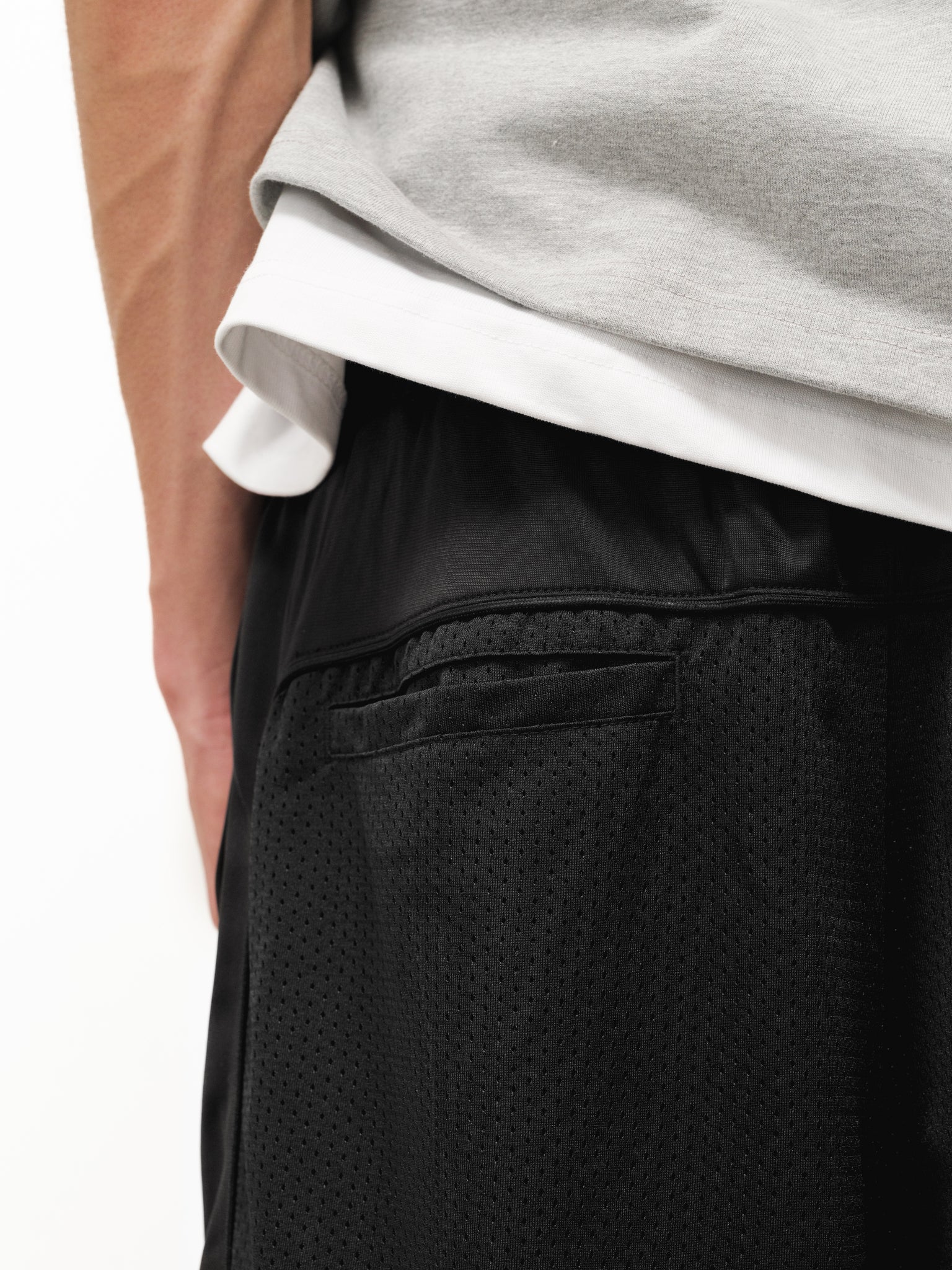 Black mesh shorts from Sweats EU displayed on a neutral background, showcasing their lightweight and breathable fabric.