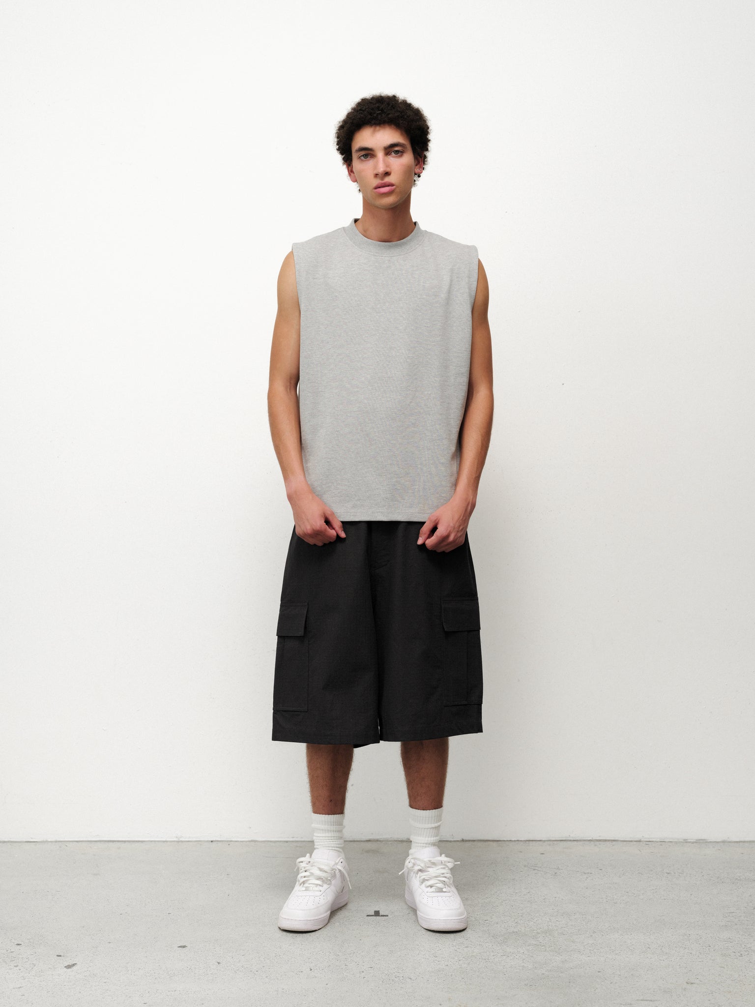 Grey Melange Muscle Tee by SWEATS EU displayed on a mannequin, highlighting its fit and soft fabric for casual athletic wear.