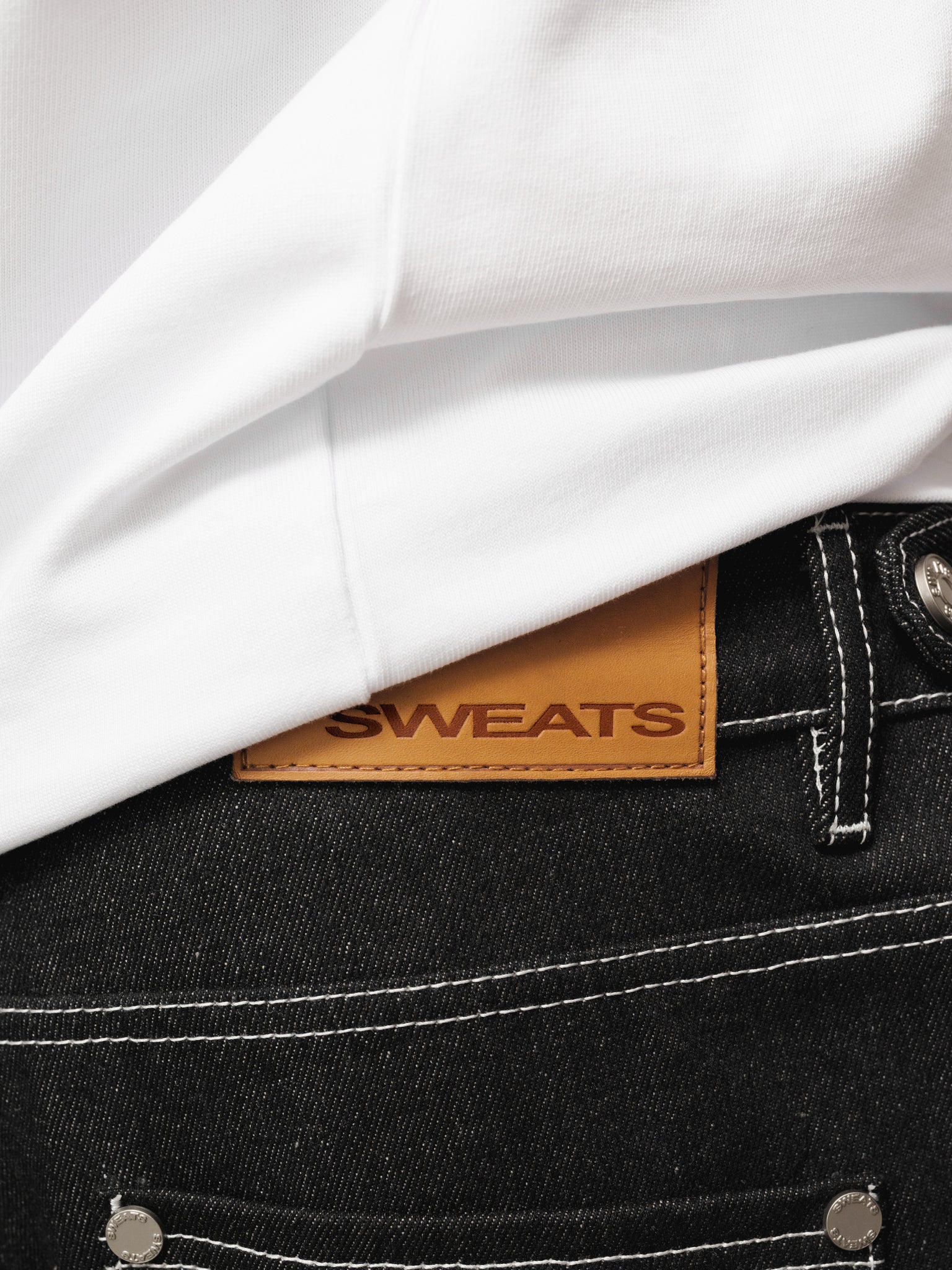 Black denim baggy jeans by SWEATS EU displayed on a model, showcasing relaxed fit and stylish casual wear.