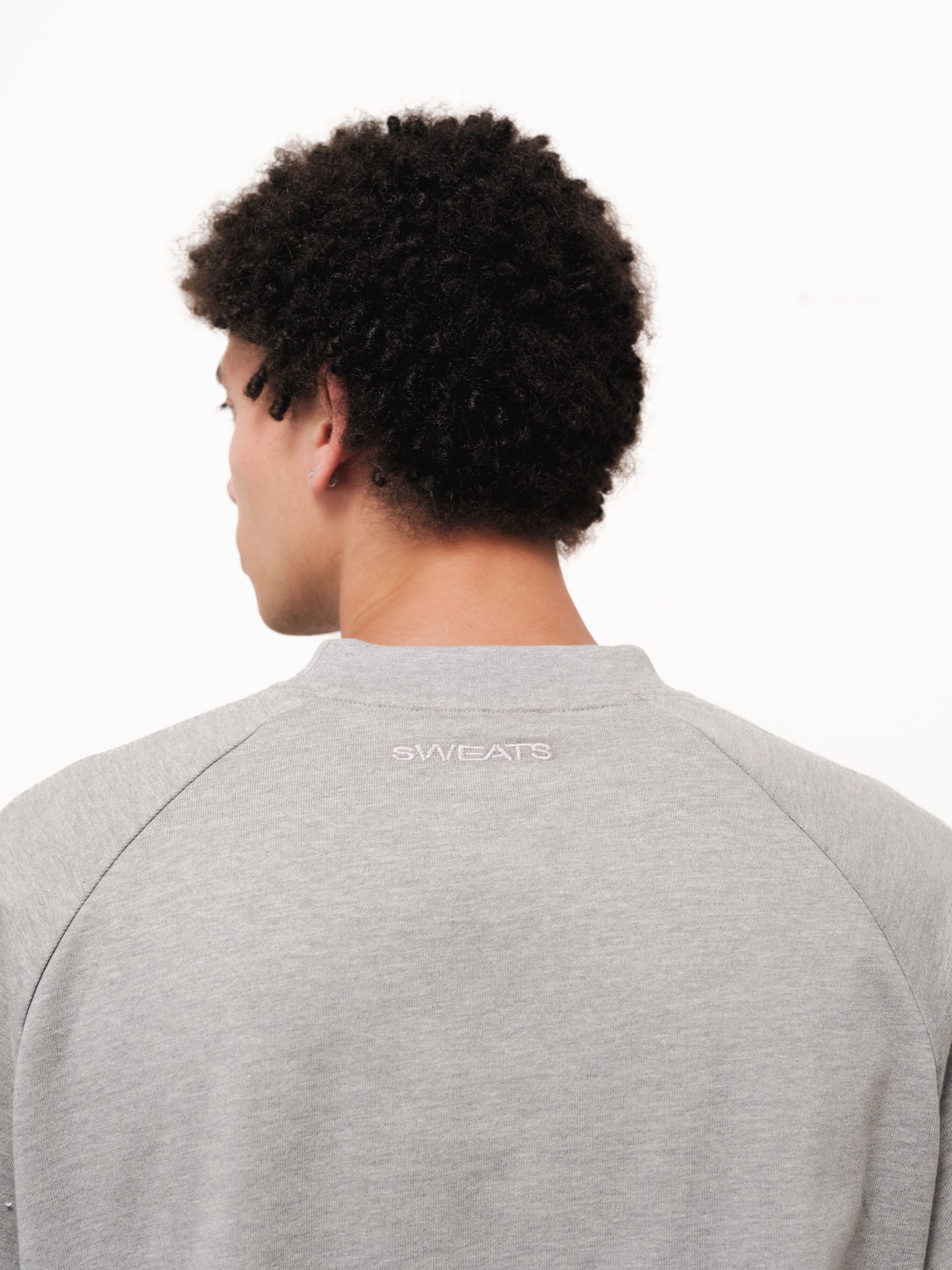 Grey long sleeve T-shirt from Sweats EU displayed on a model, showcasing a casual, comfortable fit and soft fabric.