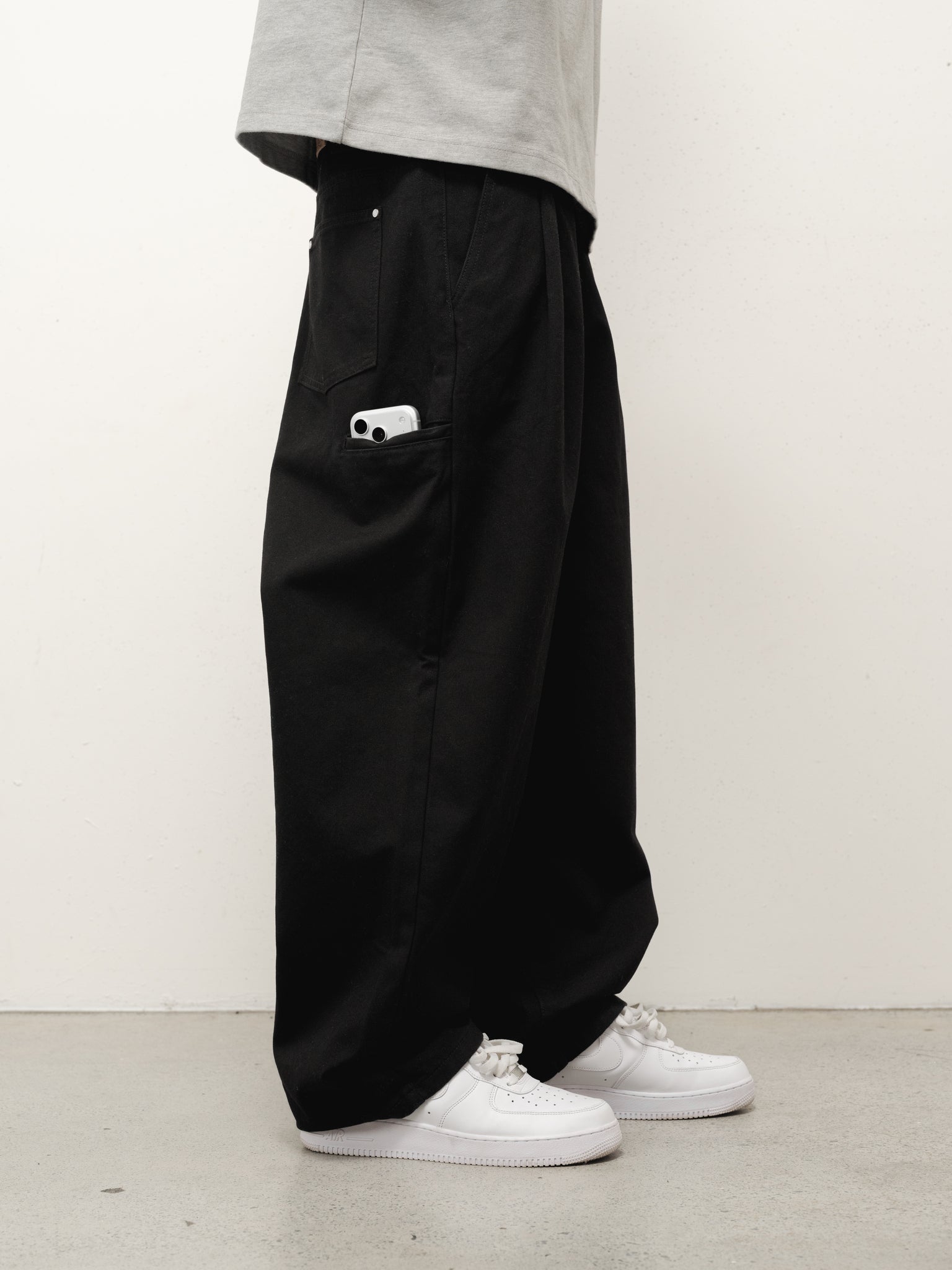 Black workwear pants by SWEATS EU, full-length view showing durable fabric and classic fit for industrial or casual work environments.