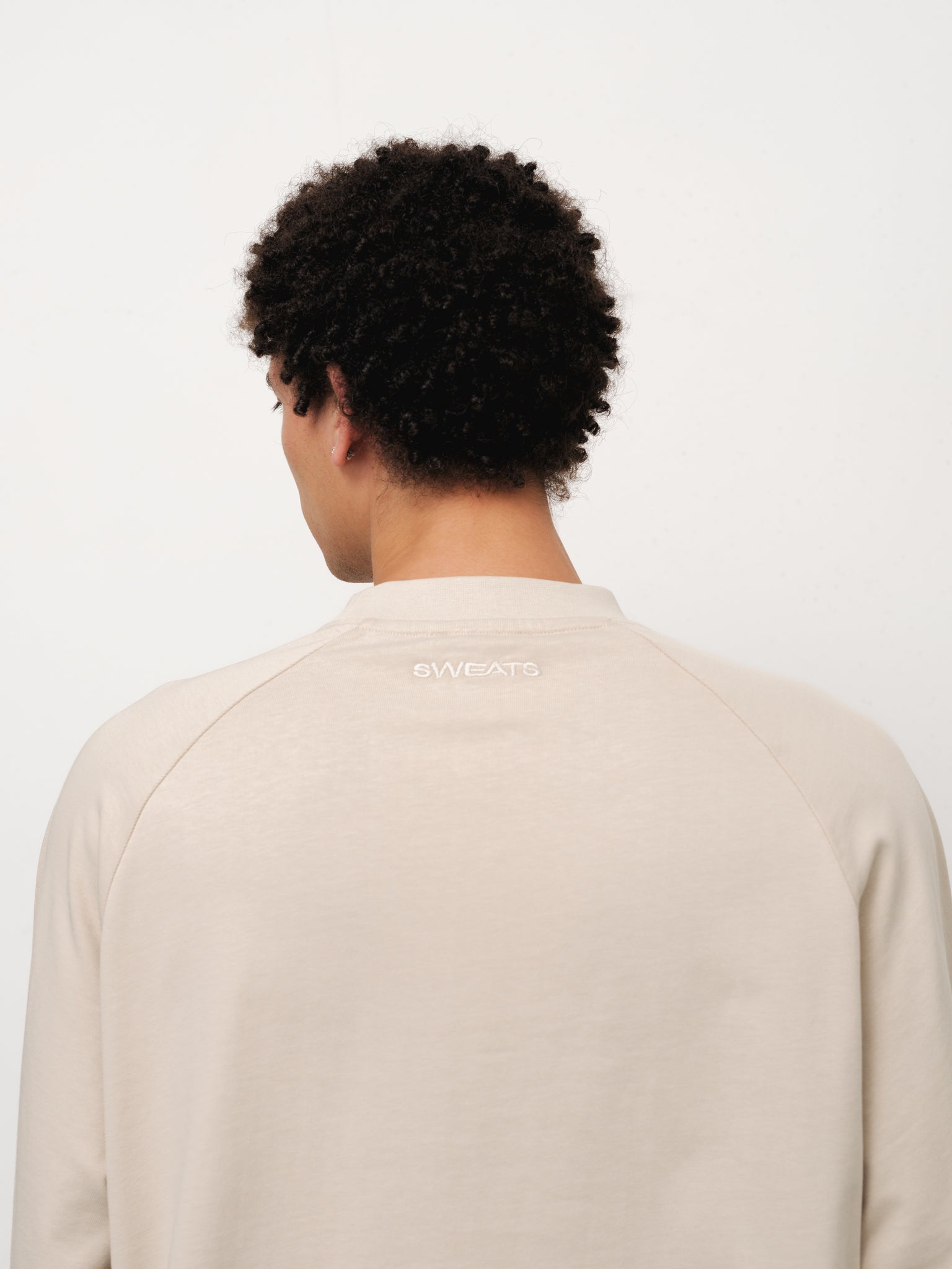 Long sleeve oat-colored T-shirt from Sweats EU displayed on a model in a full stock shoot.