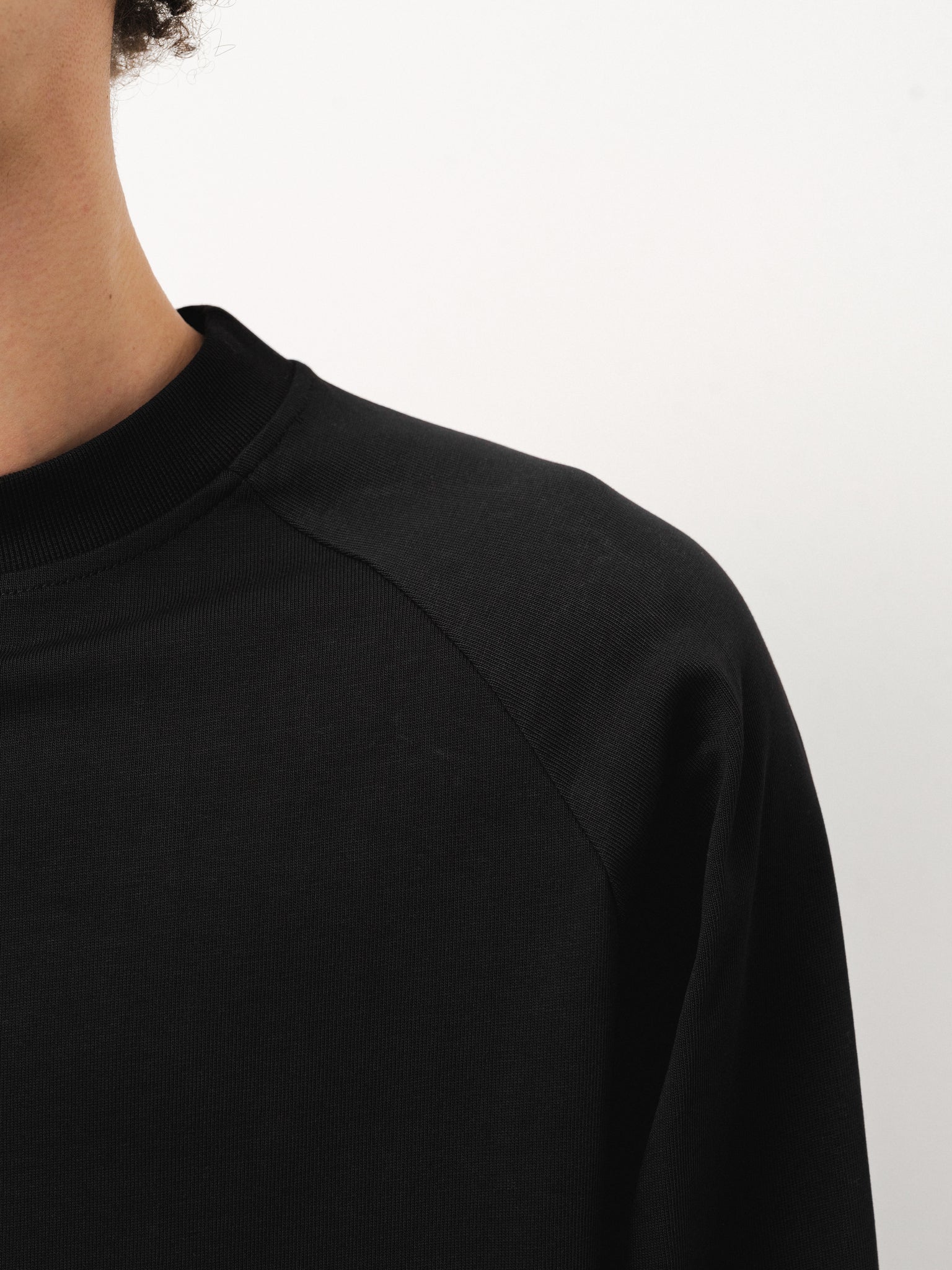Black long sleeve T-shirt by Sweats EU displayed on a model, showcasing a casual fit and classic design.