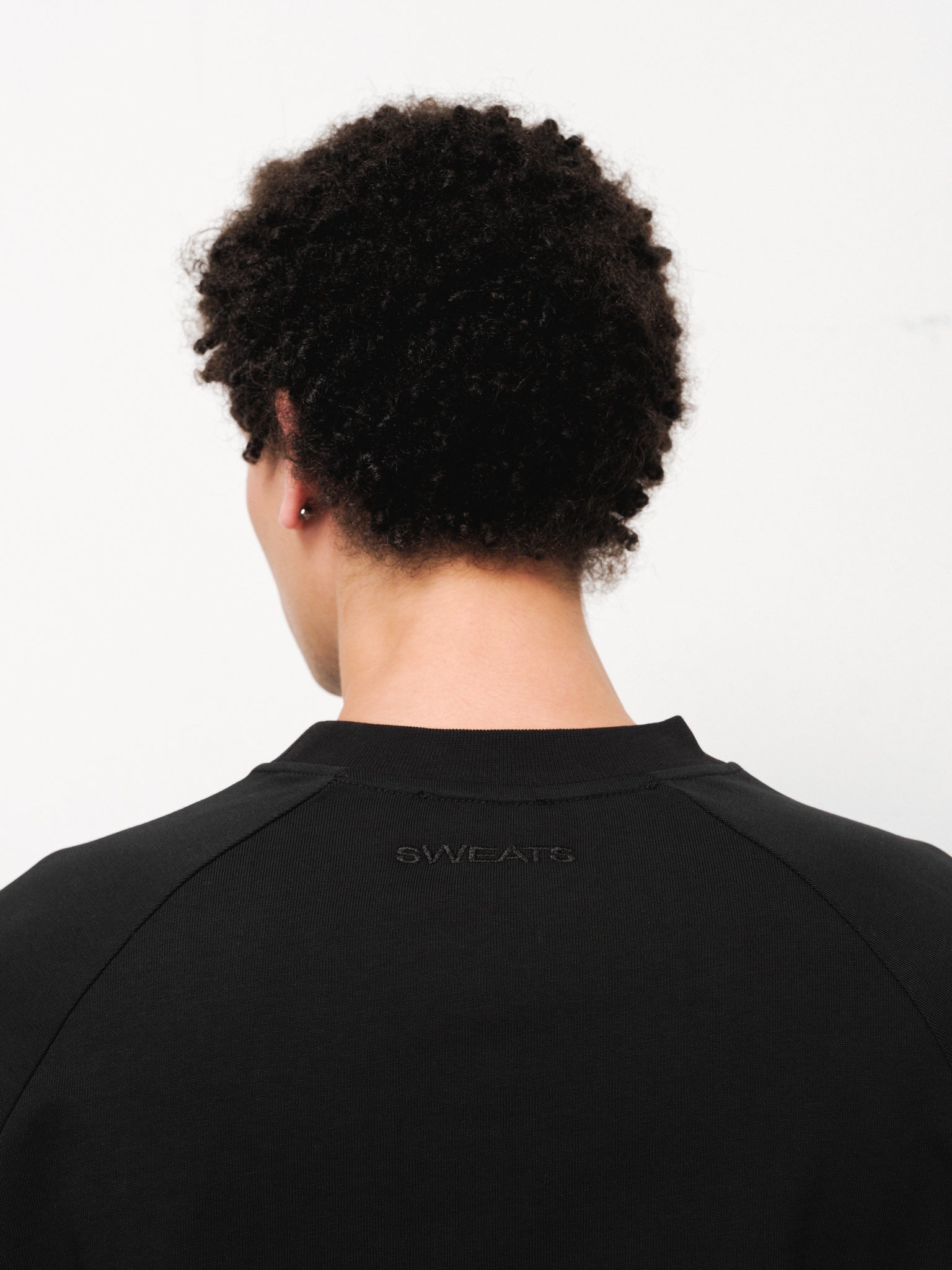 Black long sleeve T-shirt by Sweats EU displayed on a model, showcasing a casual fit and comfortable fabric.