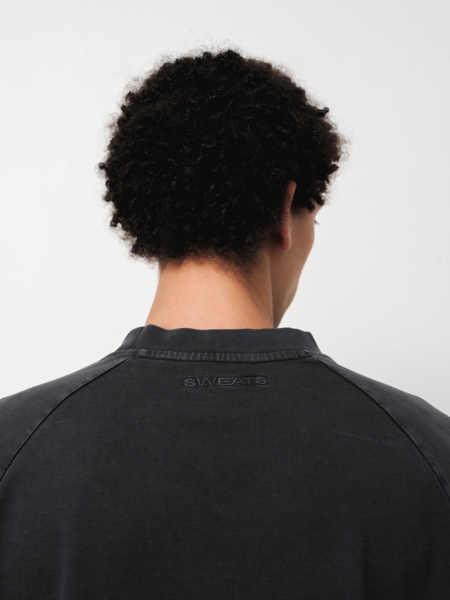 Washed black long sleeve T-shirt from Sweats EU displayed on a model in a full stock shoot.