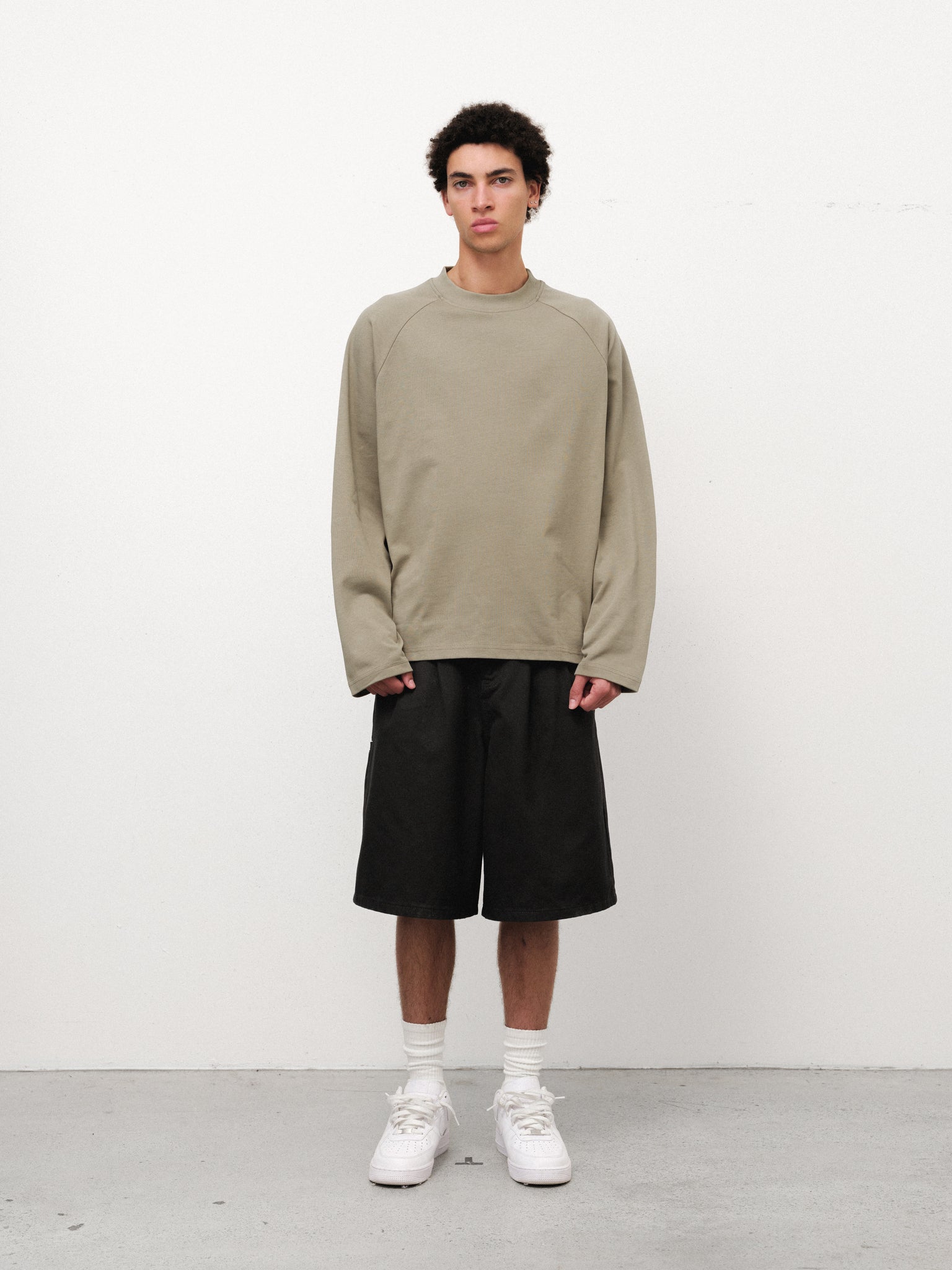 Sage long sleeve T-shirt by SWEATS EU displayed on a model, showcasing comfortable fit and casual style.