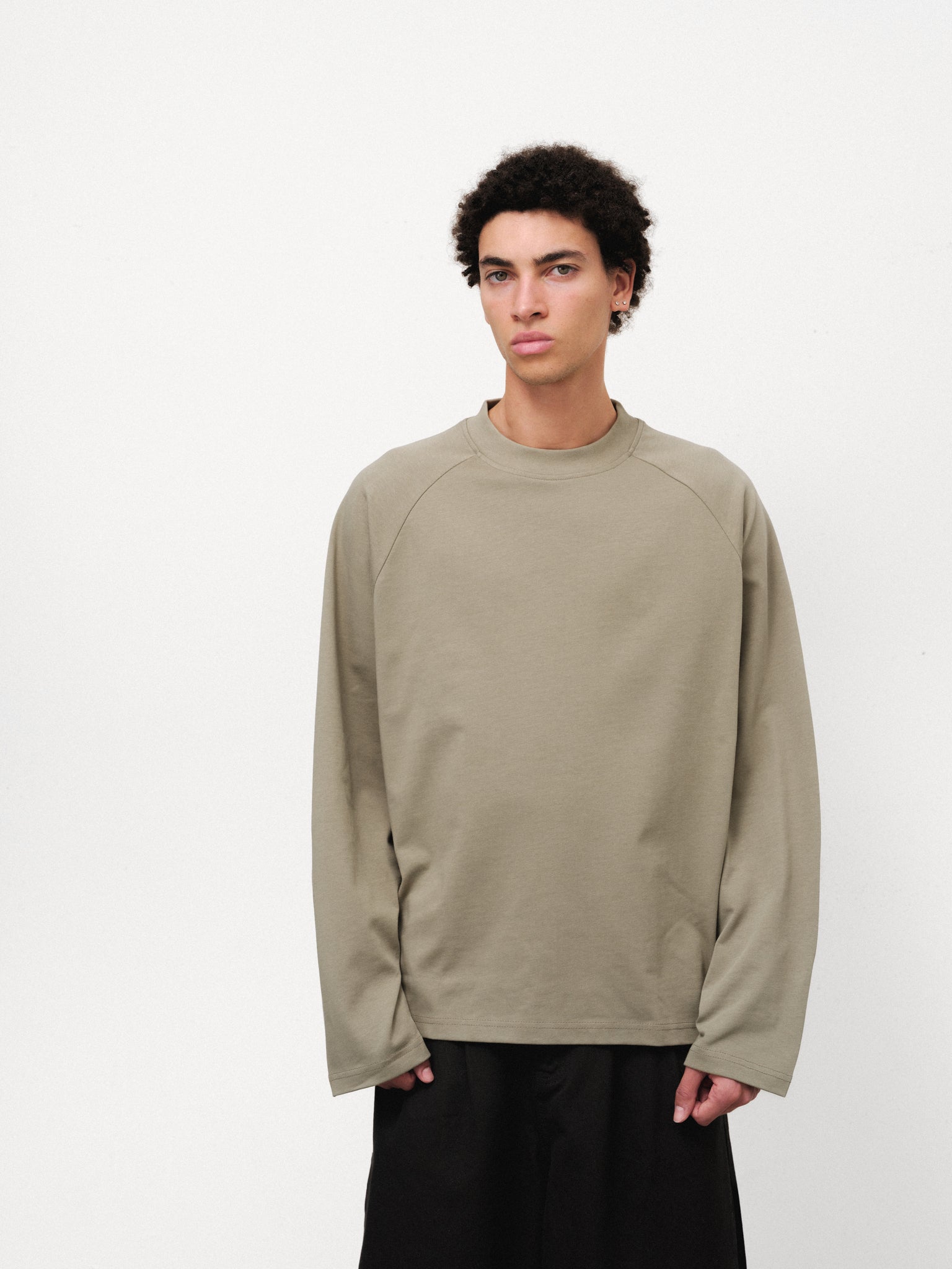 SWEATS EU long sleeve sage T-shirt displayed flat, showcasing its soft fabric and simple, stylish design.