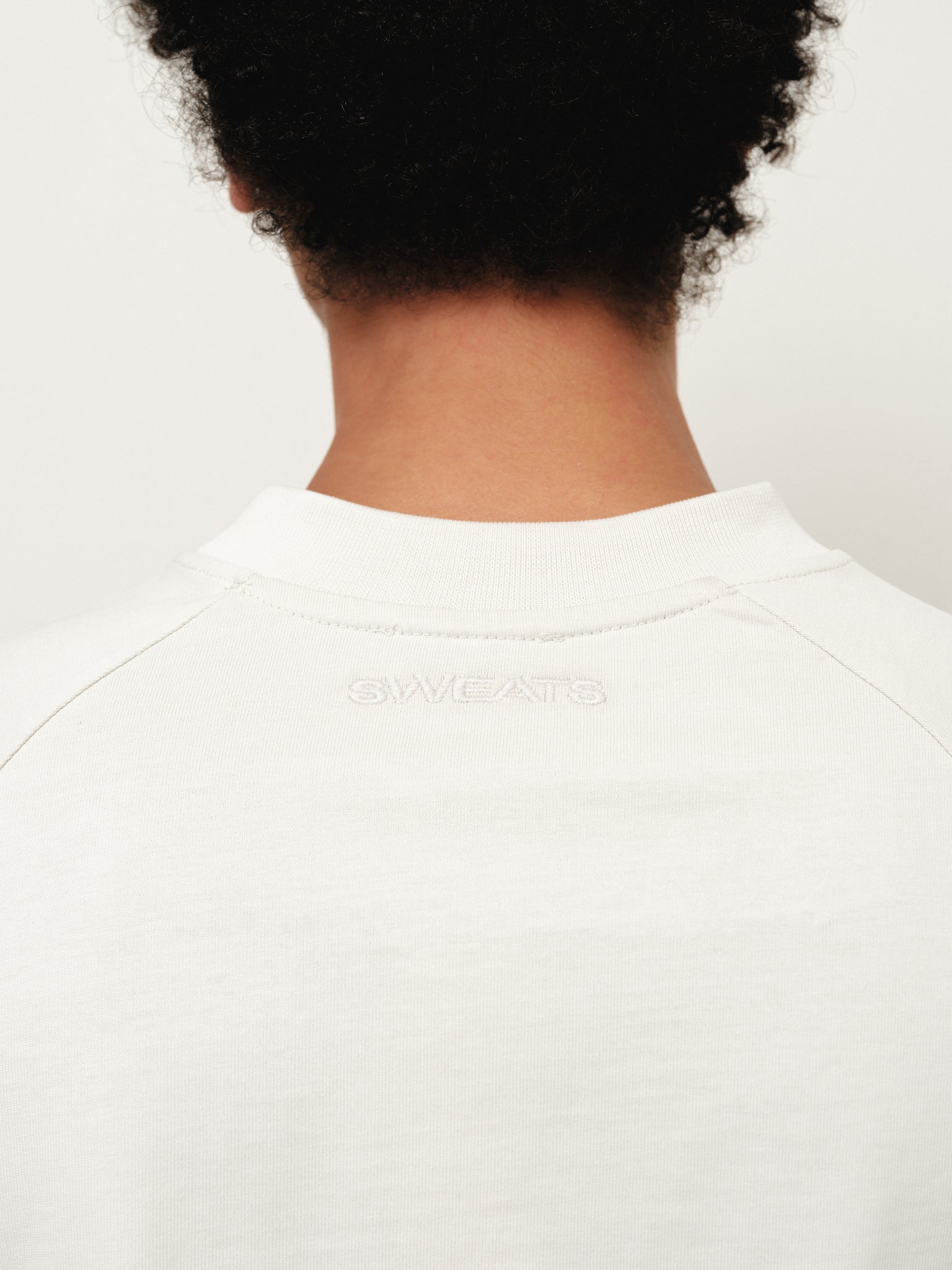 Long sleeve chalk-colored T-shirt by SWEATS EU, featuring a comfortable fit and casual style, displayed on a plain background.