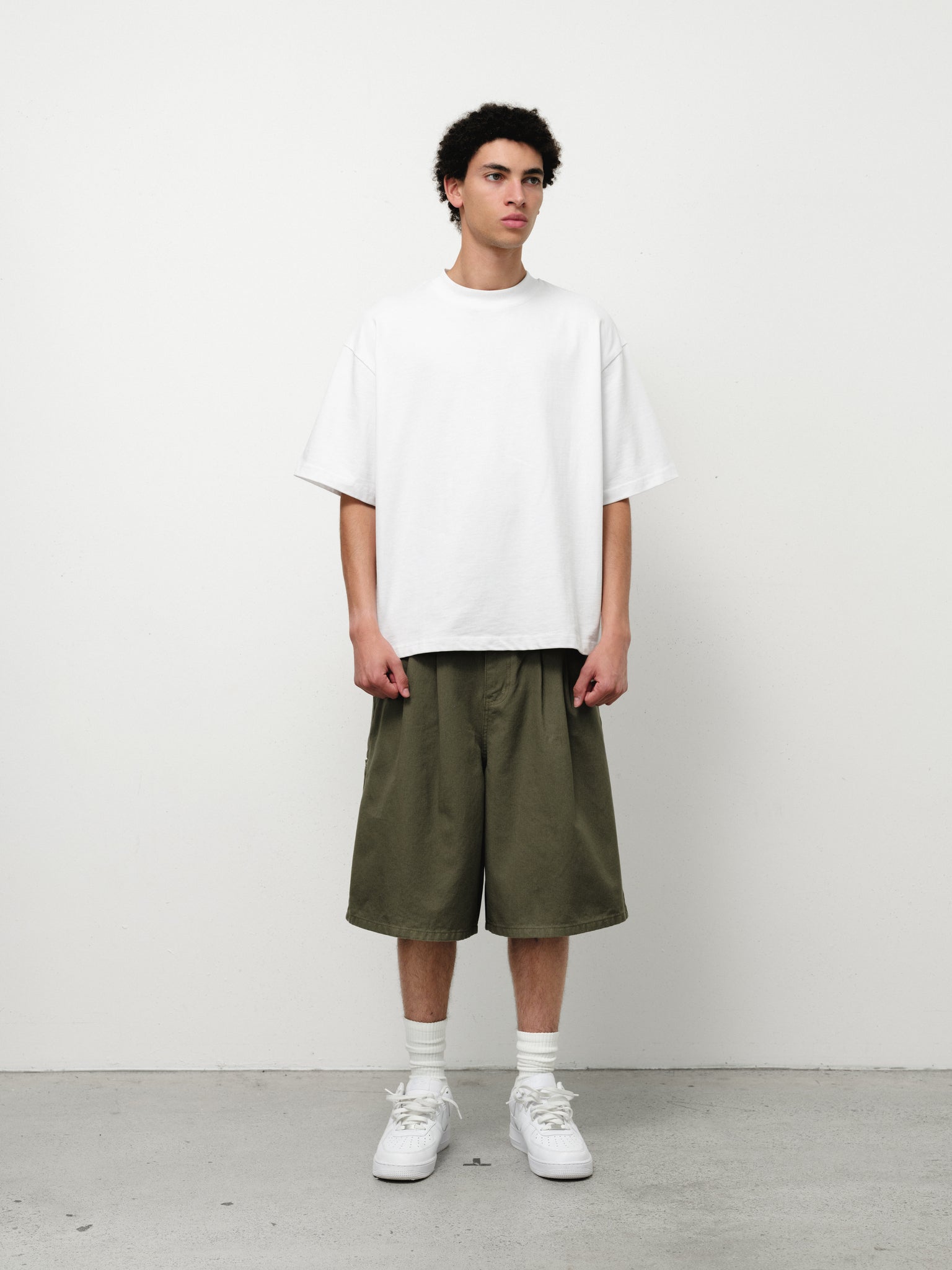 Olive workwear shorts from SWEATS EU displayed on a model, featuring durable fabric and practical design for work and casual wear.
