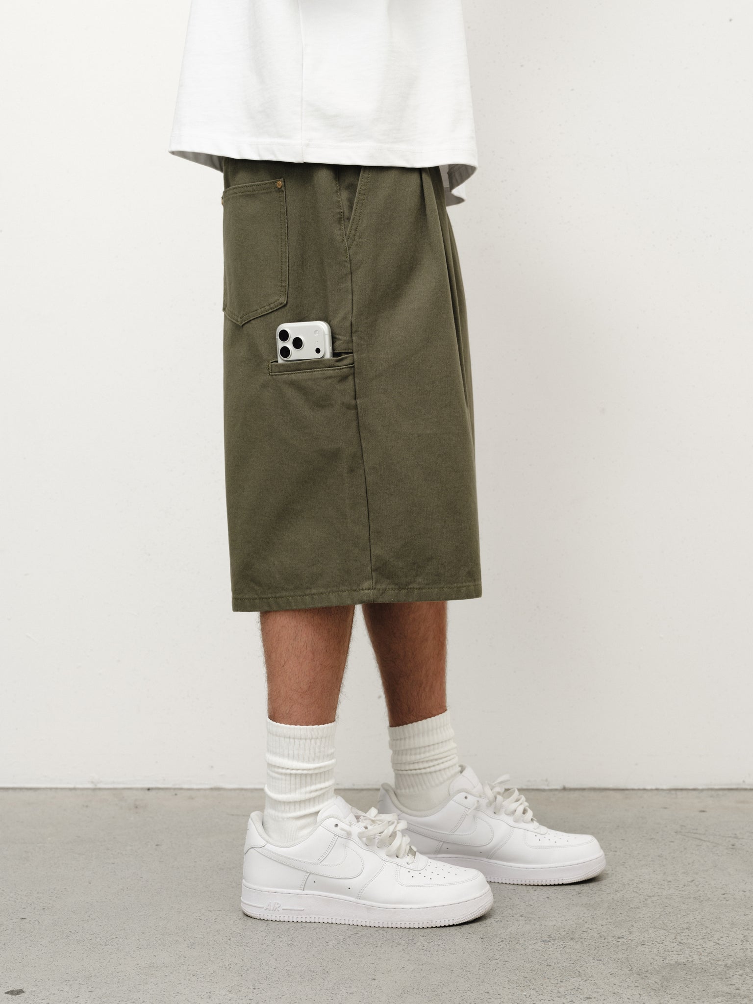 Olive workwear shorts by SWEATS EU displayed on a model, featuring durable fabric and practical design for work or casual wear.