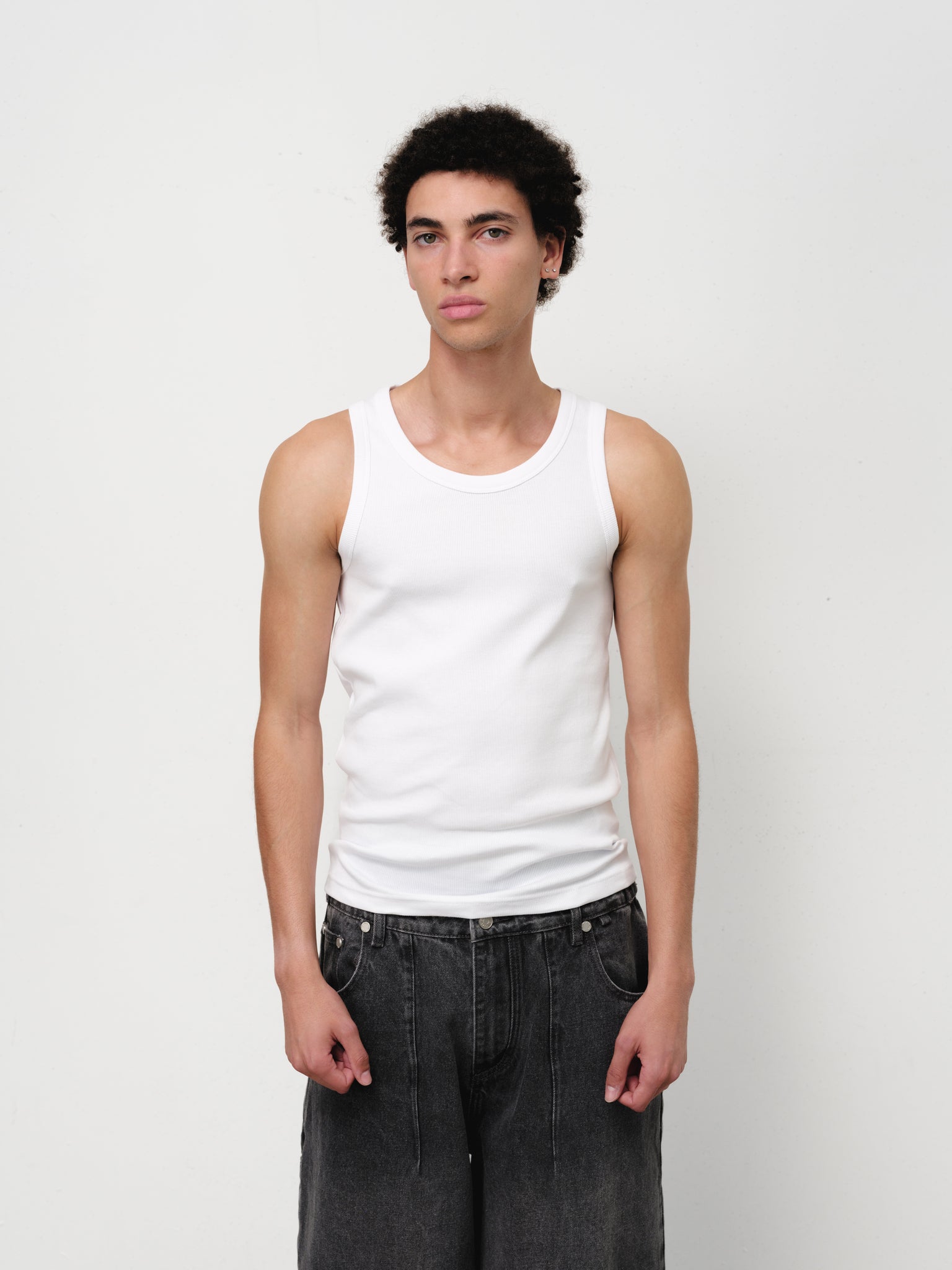 White tank singlet by Sweats EU, showing a sleeveless cotton top on a plain background.